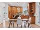 Bright, spacious kitchen with wood cabinets, large island, and views into the dining and living areas at 4094 Bimini Ct, Boulder, CO 80301