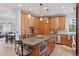 Spacious kitchen featuring wood cabinets, gray countertops, an island with seating, and stainless steel appliances at 4094 Bimini Ct, Boulder, CO 80301