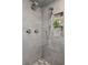 Modern shower with tiled walls, multiple shower heads, and a built-in niche for toiletries and decor at 4094 Bimini Ct, Boulder, CO 80301