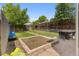 Backyard with a grassy lawn, patio, and garden bed at 2435 N Irving St, Denver, CO 80211