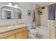 Updated bathroom features a tile shower, framed mirror and a light wood vanity at 2435 N Irving St, Denver, CO 80211