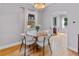 Cozy dining area featuring a round table, four chairs, and a bright window at 2435 N Irving St, Denver, CO 80211