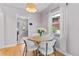 Cozy dining area featuring a round table, four chairs, and a bright window at 2435 N Irving St, Denver, CO 80211
