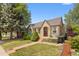 Charming brick home with a well-manicured lawn and inviting front porch seating at 2435 N Irving St, Denver, CO 80211
