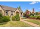 Charming brick home with a well-manicured lawn and inviting front porch seating at 2435 N Irving St, Denver, CO 80211