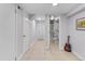 Basement hallway with tile floor, white doors, and a view into an adjacent bathroom at 2435 N Irving St, Denver, CO 80211