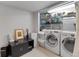 Bright laundry room with modern washer and dryer units and ample storage space at 2435 N Irving St, Denver, CO 80211