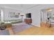 Bright living room featuring hardwood floors, modern lighting, and a comfortable couch at 2435 N Irving St, Denver, CO 80211