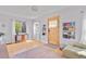Bright living room featuring hardwood floors, built-in bookshelves, and a sunlit window at 2435 N Irving St, Denver, CO 80211