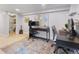 Office space with dual workstations, a modern rug and an adjacent full bathroom at 2435 N Irving St, Denver, CO 80211