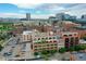 This aerial view captures the city skyline featuring residential and commercial buildings, with a parking lot for convenience at 1435 Wazee St # 408, Denver, CO 80202