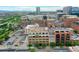 This is an aerial view showcasing an attractive urban scene with the property surrounded by buildings and parking spaces at 1435 Wazee St # 408, Denver, CO 80202