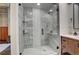 Elegant bathroom with glass shower, decorative tiles, and modern vanity with marble countertop at 1435 Wazee St # 408, Denver, CO 80202