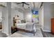 Cozy bedroom featuring a rustic wood bed frame, exposed ceiling, and modern lighting fixture. Artwork on wall at 1435 Wazee St # 408, Denver, CO 80202