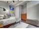 Cozy bedroom featuring a bed, wooden chest, and an abstract painting on the wall at 1435 Wazee St # 408, Denver, CO 80202