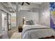 Comfortable bedroom with exposed ceiling, industrial lighting, and a barn door leading to the bathroom at 1435 Wazee St # 408, Denver, CO 80202