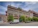 Attractive multi-story brick building with multiple windows and mature trees lining the street at 1435 Wazee St # 408, Denver, CO 80202