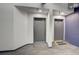 Hallway featuring neutral walls, carpet floors, base trim, and apartment doors at 1435 Wazee St # 408, Denver, CO 80202