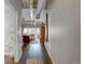 Hallway leading to a bright living room with exposed ceiling and large windows at 1435 Wazee St # 408, Denver, CO 80202