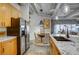 Open kitchen design highlighting stainless steel appliances, light wood cabinetry, and industrial-style ceiling at 1435 Wazee St # 408, Denver, CO 80202