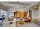 Airy living room with a comfy white sofa, unique wood storage, and an industrial-style ceiling with exposed pipes at 1435 Wazee St # 408, Denver, CO 80202