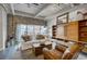 Bright living room with brick accents, a comfortable white sofa, and stylish wood storage and display cabinet at 1435 Wazee St # 408, Denver, CO 80202