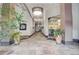Inviting lobby area with tiled floors, pendant lighting, plants, and an office in the background at 1435 Wazee St # 408, Denver, CO 80202