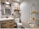 Charming powder room featuring a rustic wood accent wall, modern fixtures, and decorative shelving at 1435 Wazee St # 408, Denver, CO 80202