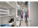 Well-organized walk-in closet with built-in shelving and laundry area featuring a red dryer at 1435 Wazee St # 408, Denver, CO 80202