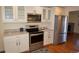 Modern kitchen with stainless steel appliances and hardwood floors at 3516 W Powers Pl, Littleton, CO 80123