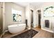 Elegant bathroom featuring a free-standing tub and walk-in shower at 18722 W 87Th Ave, Arvada, CO 80007