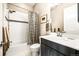 Clean bathroom with shower/tub combo and dark vanity at 18722 W 87Th Ave, Arvada, CO 80007