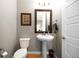 Small powder room with pedestal sink and neutral color palette at 18722 W 87Th Ave, Arvada, CO 80007