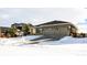 House exterior with two car garage and snow covered yard at 18722 W 87Th Ave, Arvada, CO 80007