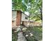 Charming brick and siding exterior with mature trees and a wooden fence at 64 Nome Way # C, Aurora, CO 80012