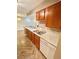 Charming kitchen featuring wood-look floors, ample counter space, and modern white appliances at 64 Nome Way # C, Aurora, CO 80012