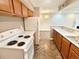 Modern kitchen with stove, updated appliances, and open access to living area at 64 Nome Way # C, Aurora, CO 80012