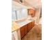 Updated kitchen with stainless steel sink, breakfast bar, and warm wood cabinets at 64 Nome Way # C, Aurora, CO 80012