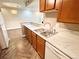 Bright kitchen with stainless steel sink, wood cabinets, and updated appliances at 64 Nome Way # C, Aurora, CO 80012