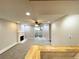 Bright living room with a fireplace, ceiling fan, and sliding glass doors to the exterior at 64 Nome Way # C, Aurora, CO 80012