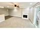 Inviting living room with plush carpet, fireplace, and sliding glass door at 64 Nome Way # C, Aurora, CO 80012