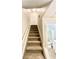 Carpeted stairway leading upstairs with an adjacent bathroom at 64 Nome Way # C, Aurora, CO 80012