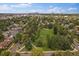 Overhead view of the park with mature trees and lush green space in a well-established neighborhood at 1626 S Sherman St, Denver, CO 80210