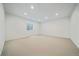 Spacious basement with carpet and natural light through an egress window at 1626 S Sherman St, Denver, CO 80210