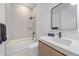 Modern bathroom featuring tiled shower over tub, floating vanity, and matte black fixtures at 1626 S Sherman St, Denver, CO 80210