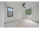Sunlit bedroom with modern ceiling fan and two bright windows at 1626 S Sherman St, Denver, CO 80210