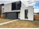Modern two-story home with neutral colors and a well-manicured lawn at 1626 S Sherman St, Denver, CO 80210
