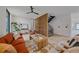 Bright living room features an open floor plan, hardwood floors, and a modern staircase with a decorative wood divider at 1626 S Sherman St, Denver, CO 80210