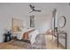 Bright main bedroom with natural light, wood floors, and black fan at 1626 S Sherman St, Denver, CO 80210