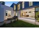 An open modern home with large windows overlooks an outdoor patio space adjacent to the kitchen and office area at 1626 S Sherman St, Denver, CO 80210